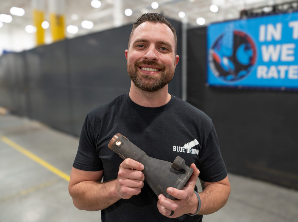 Blue Origin employee holding a thrust chamber in the company’s Jemison facility in Huntsville, Alabama. (Photo Credit: Blue Origin)